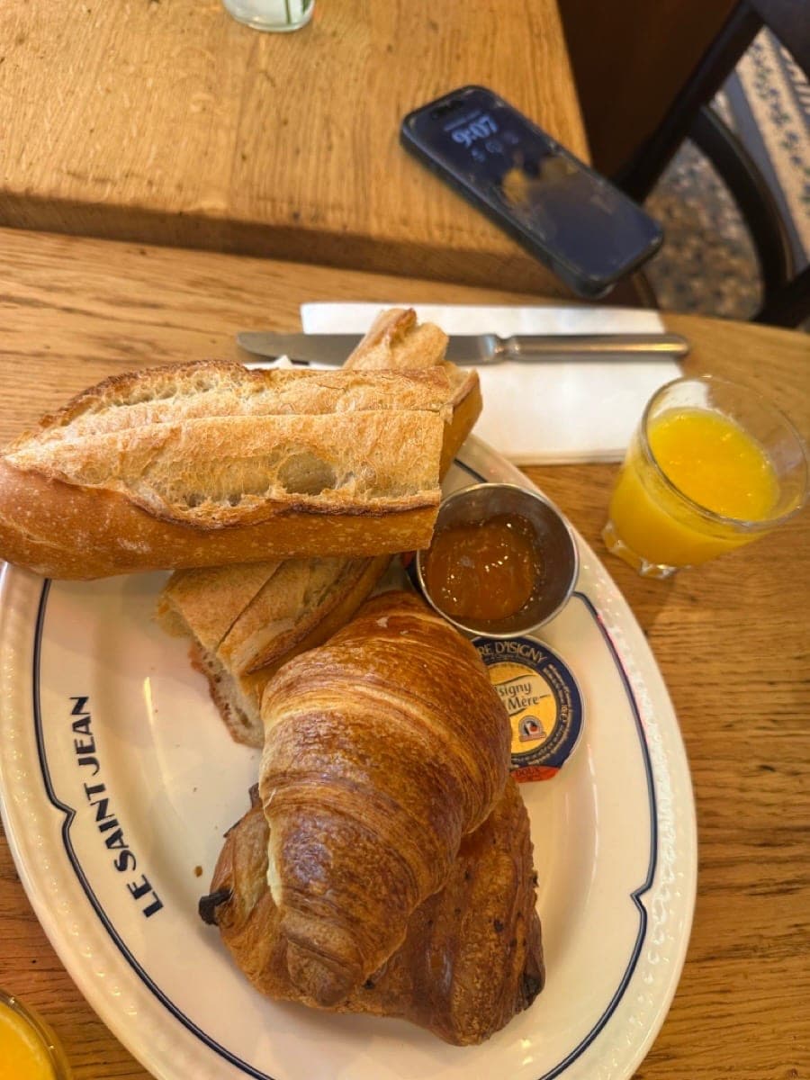 Classic French breakfast with croissant and baguette at a Paris café